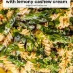 Fusilli pasta and asparagus with a slice of lemon and text overlay: Vegan Asparagus Pasta with Lemony Cashew Cream Sauce.