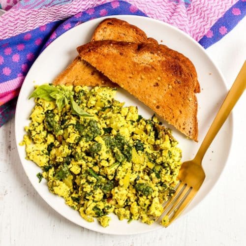 Plate of tofu scramble and toast with a gold fork
