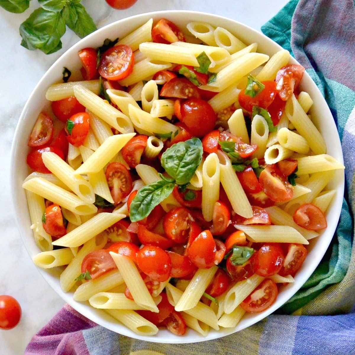 Bowl of penne topped with cherry tomato sauce