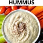 Bowl of hummus garnished with sumac and surrounded by raw vegetables with text overlay: Creamy Oil-Free White Bean Hummus.