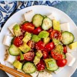 Soft tofu salad with tomatoes, cucumbers, and avocados, with text overlay: Silken Tofu Salad with Avocado and Ume Plum Dressing.