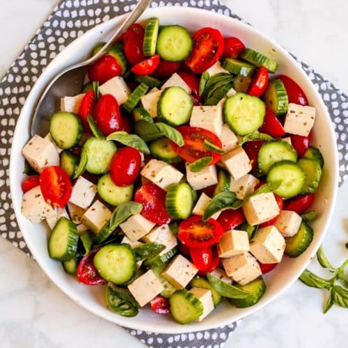 Bowl of salad on a gray and white napkin