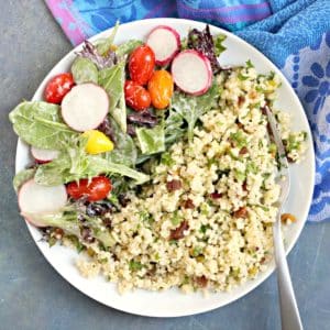Mediterranean Millet on a plate with a salad.