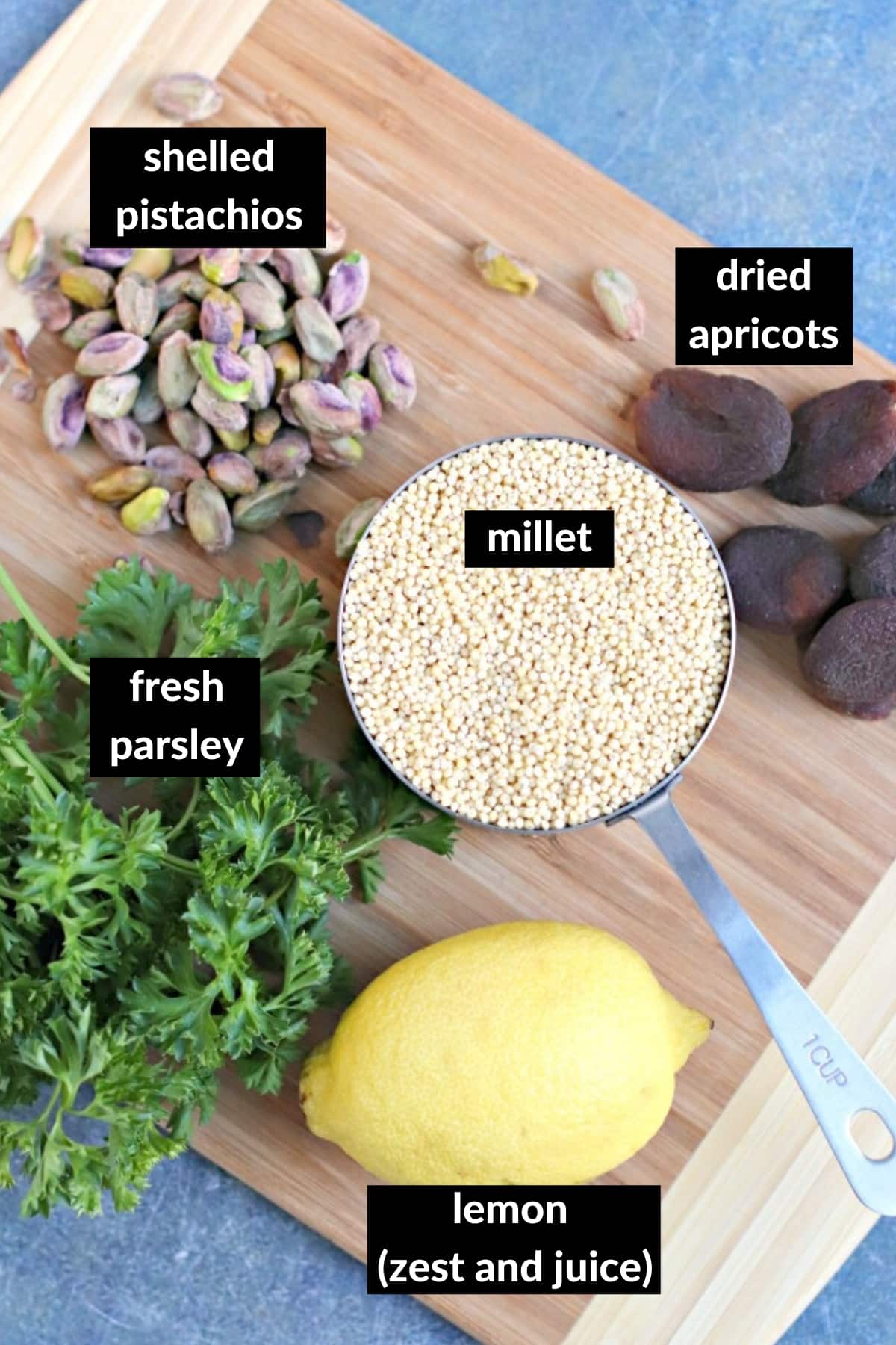 Ingredients needed to make this millet recipe on a wooden cutting board.