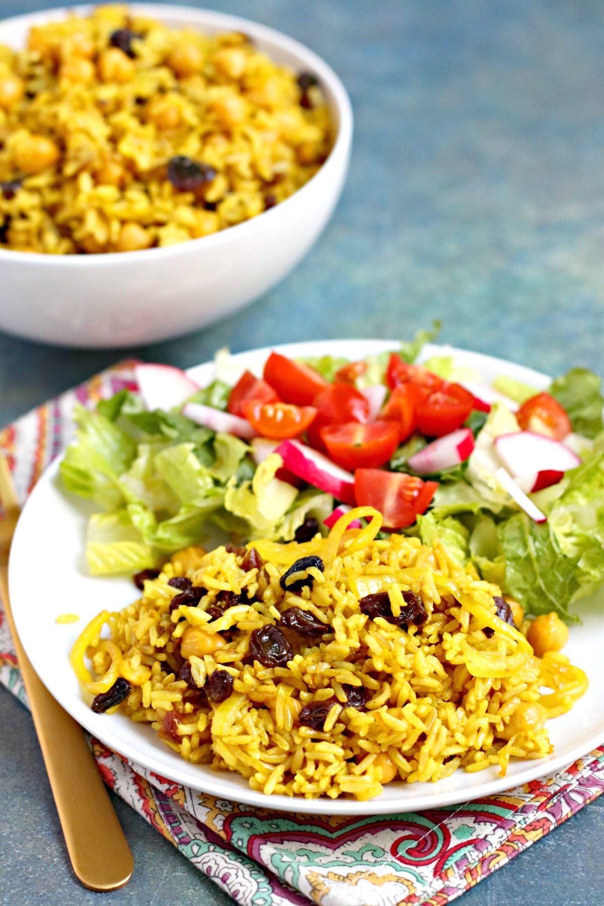 Dinner plate with mixed green salad and serving of rice pilaf.