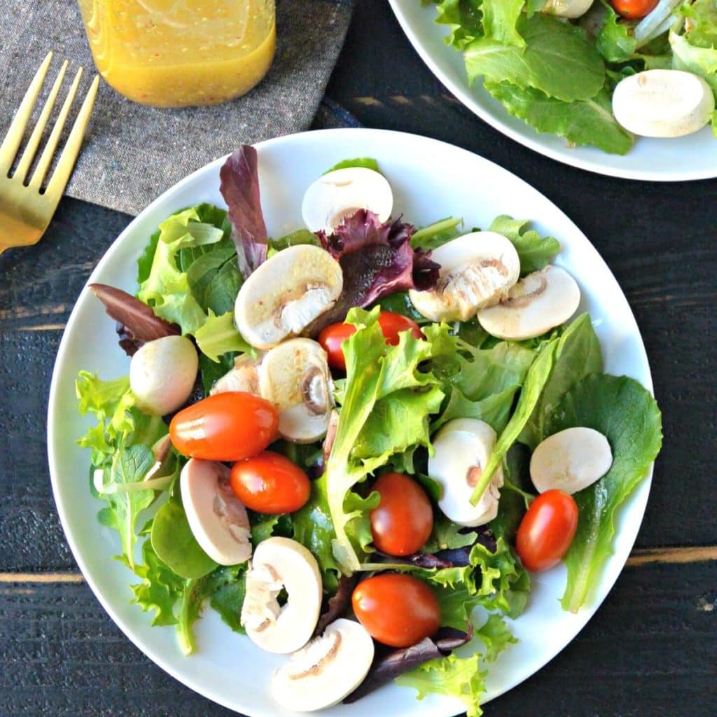 Salad on a plate with tomatoes and mushrooms