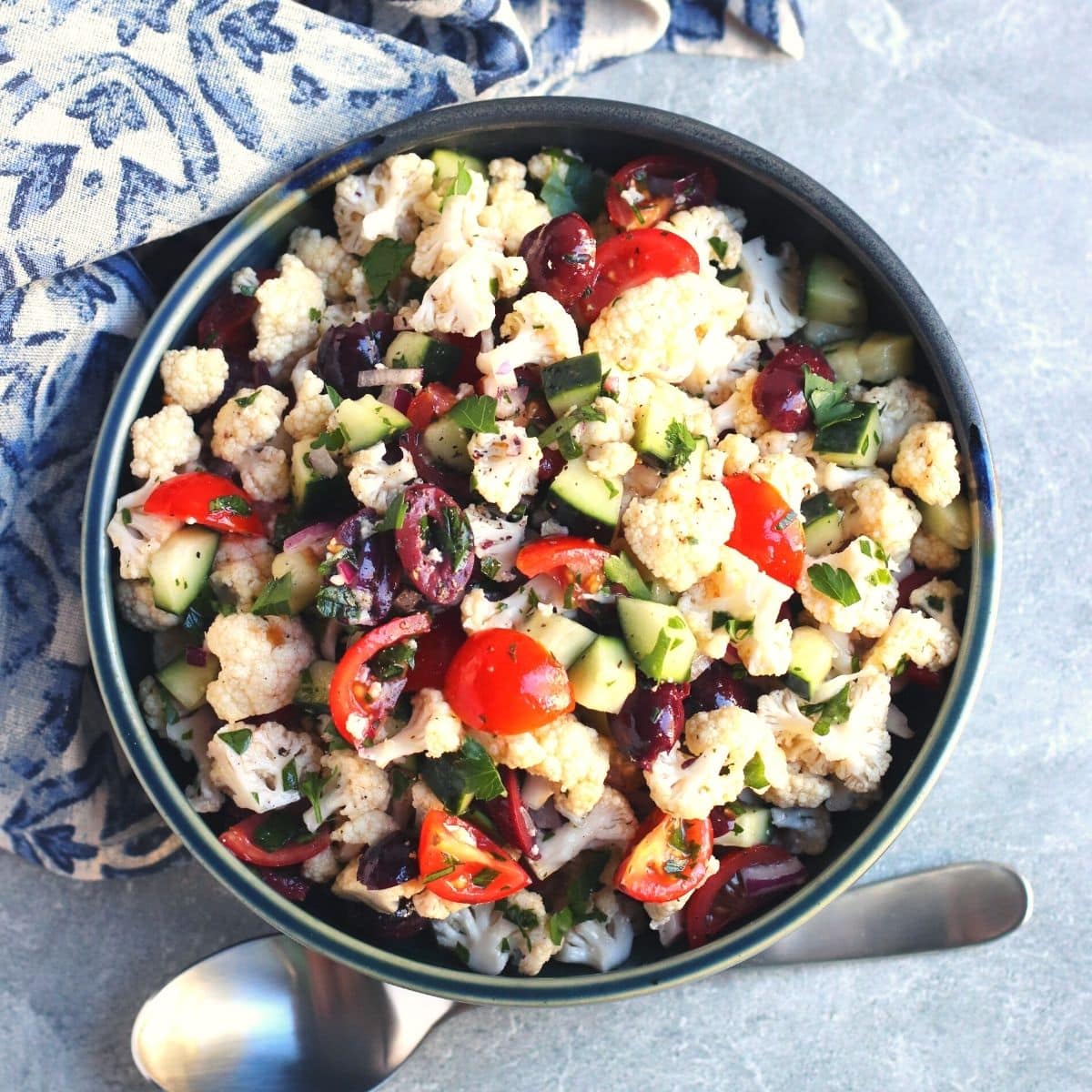 Bowl of Mediterranean Cauliflower Salad and serving spoon