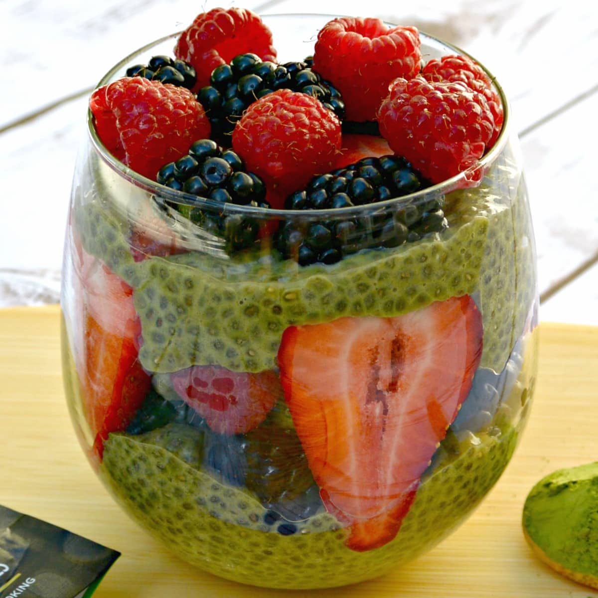 Matcha green tea chia pudding topped with raspberries, blackberries, and strawberries