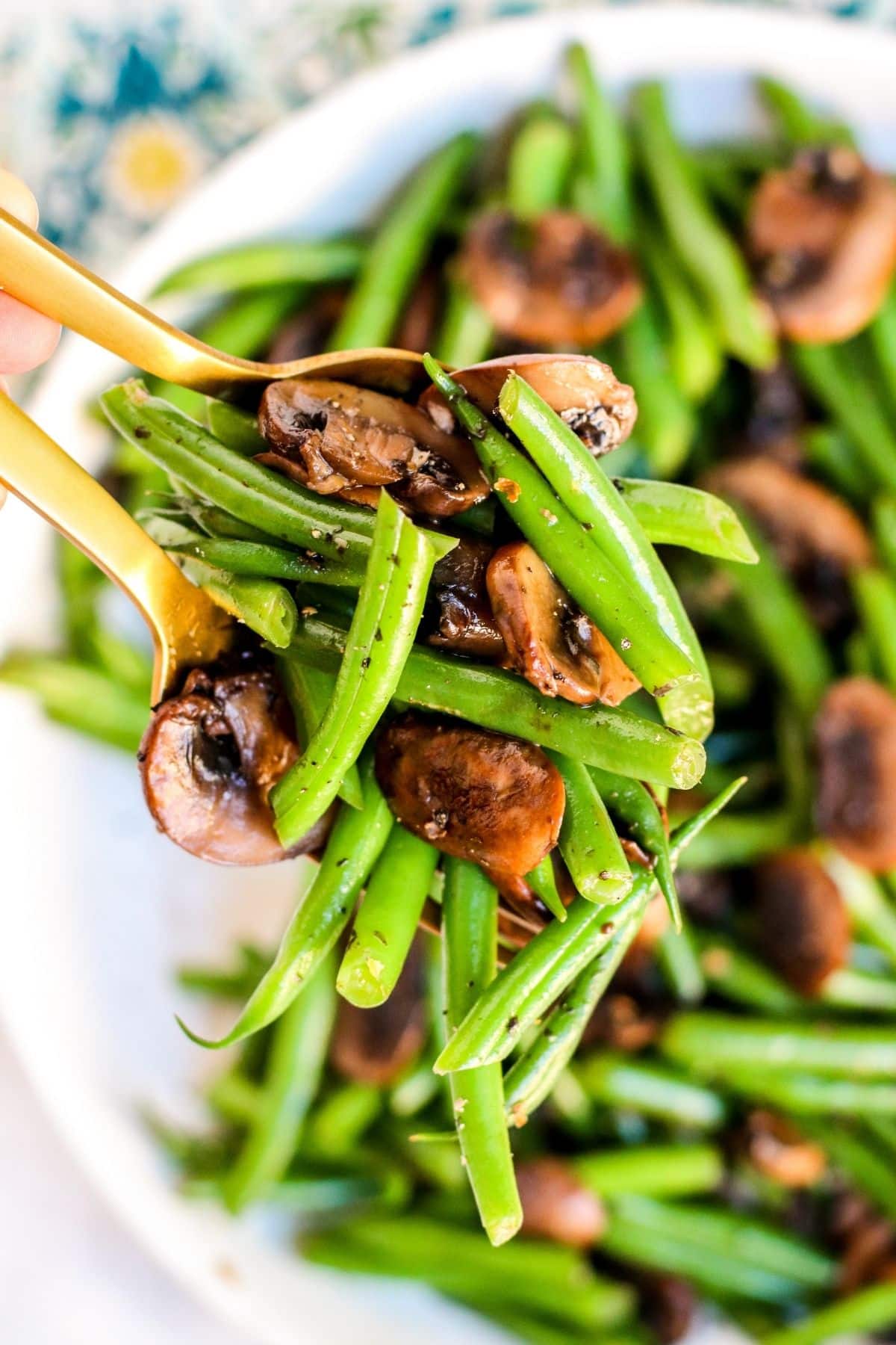 Close up image of vegetables held in serving spoons