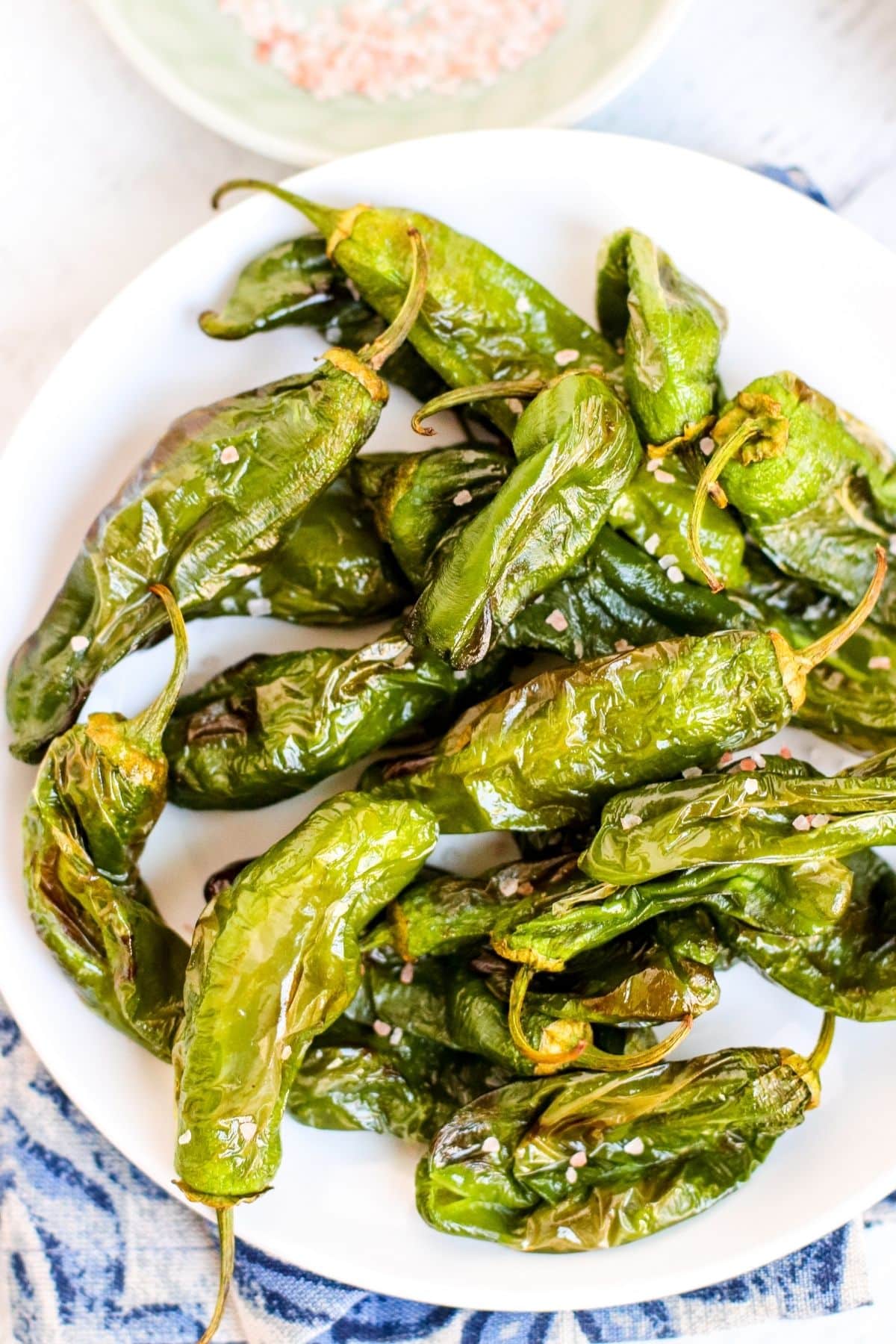 Plate of air fried peppers sprinkled with salt crystals