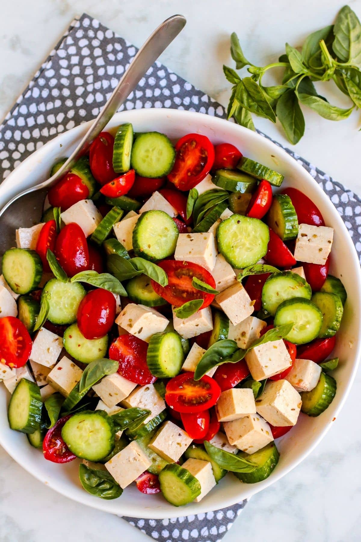 Serving bowl of Mediterranean Cucumber Tomato Salad with Tofu Feta.