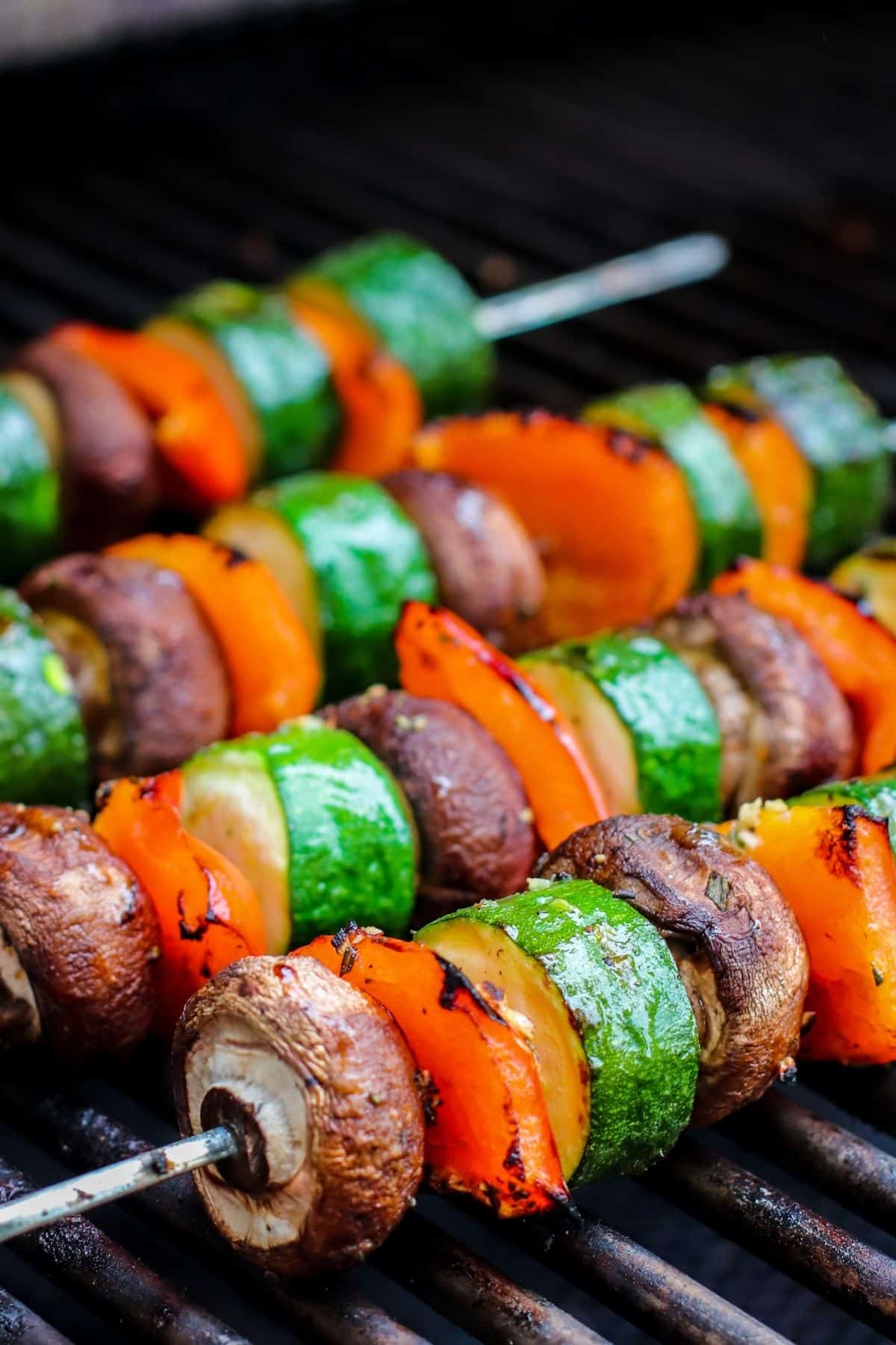 Close up image of vegetable kabobs on a barbecue grill