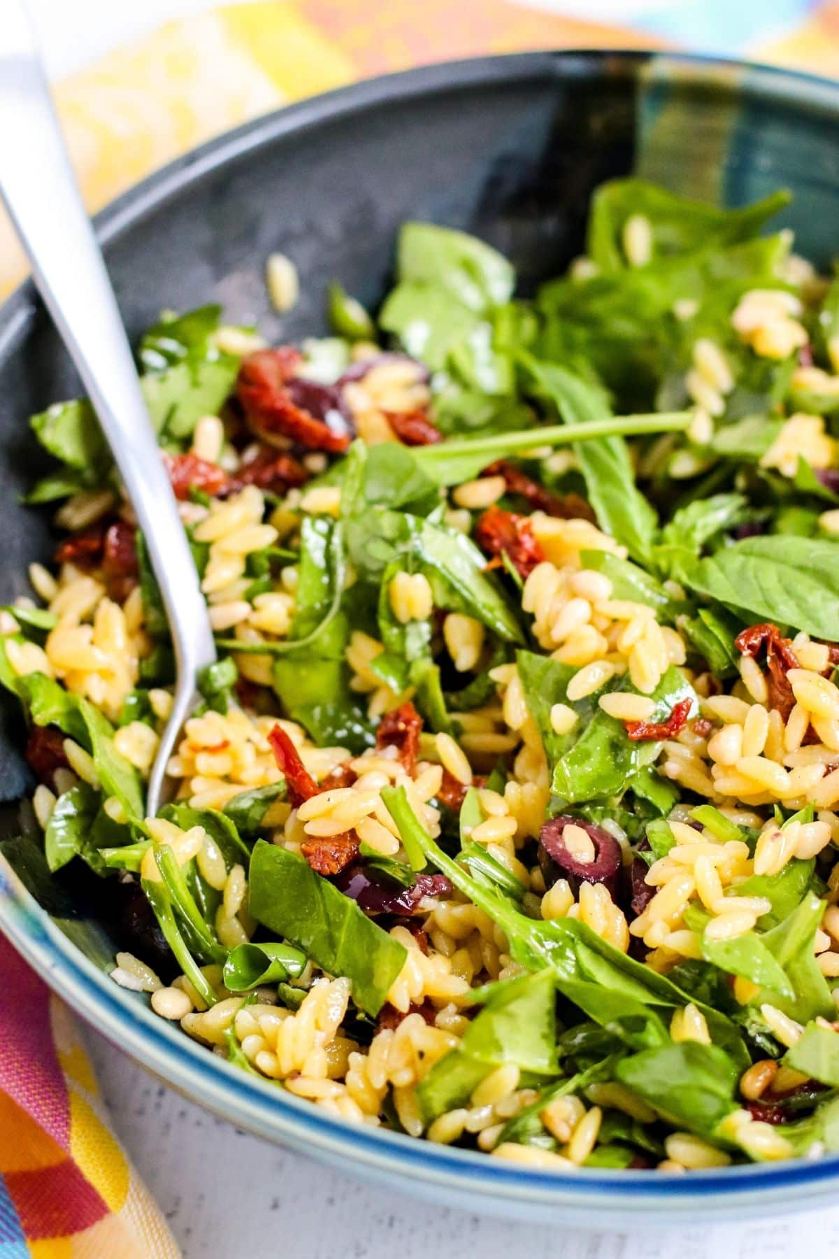 Close up detail of salad with a serving spoon in it