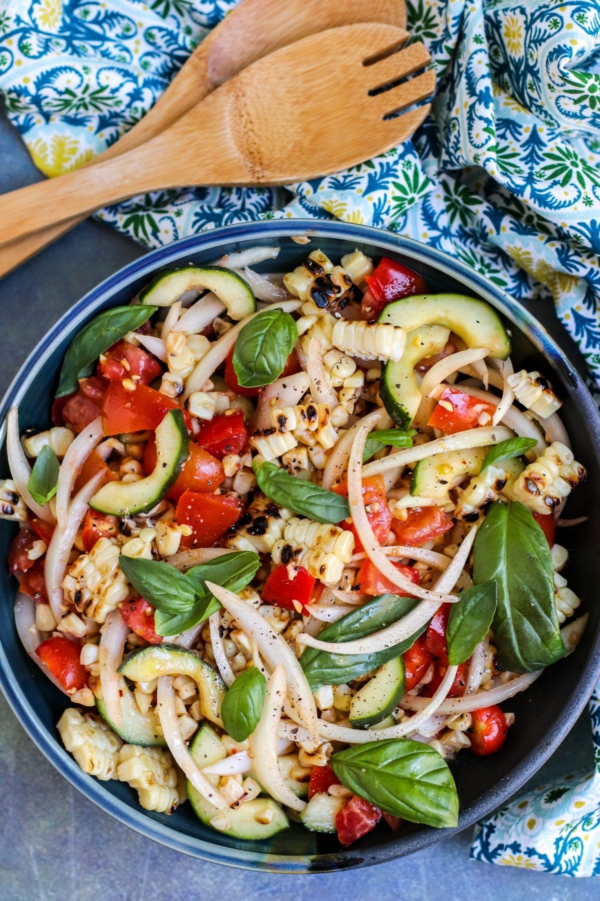 Bowl of corn salad and serving utensils