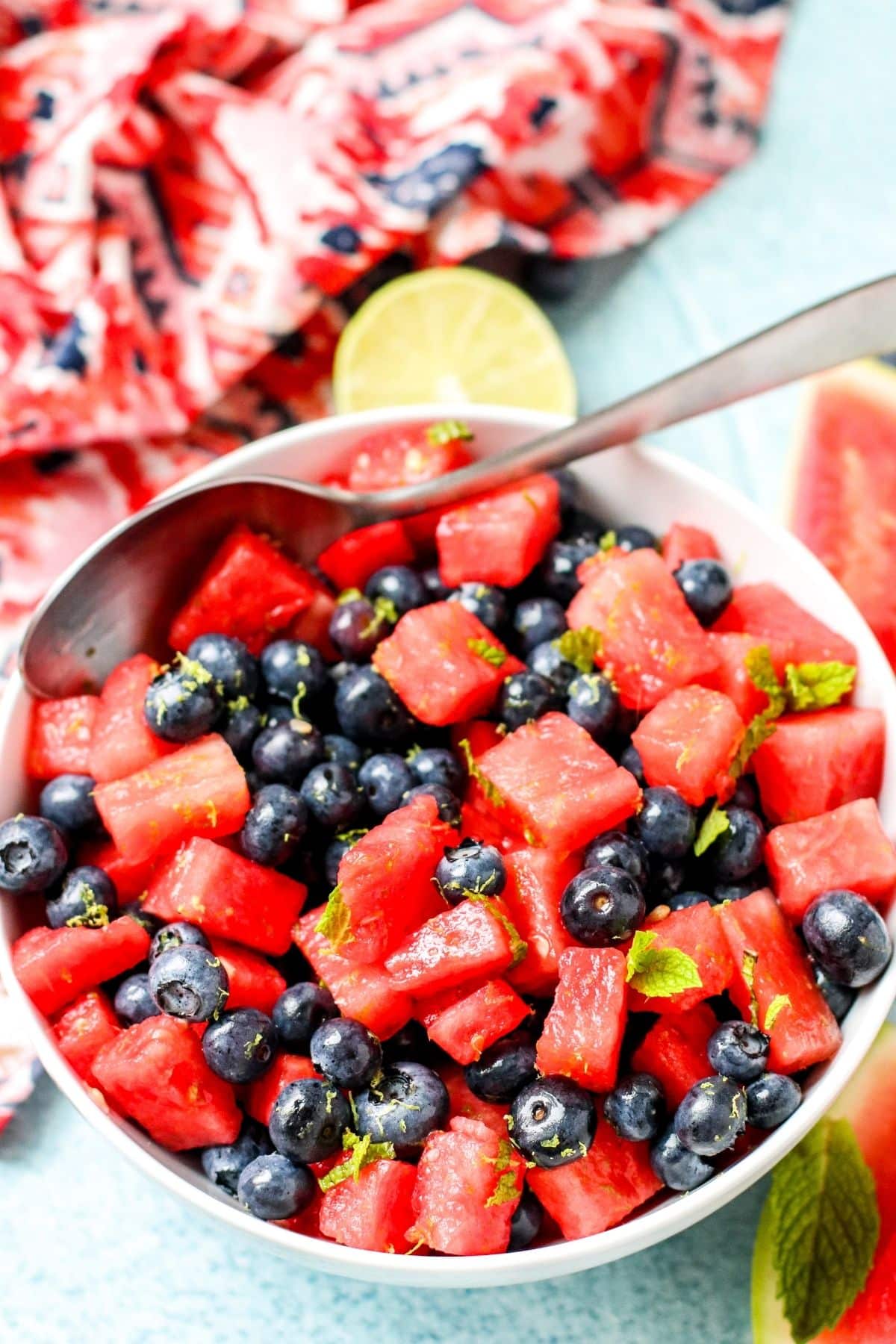 Bowl of fruit salad with serving spoon in it