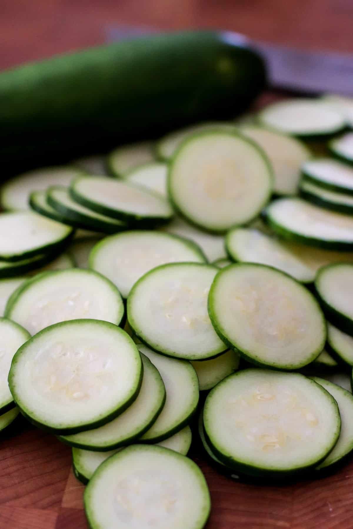 Zucchini sliced in rounds on a cutting board