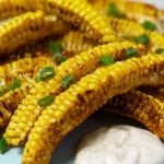 Corn ribs on a plate with a dollop of sauce