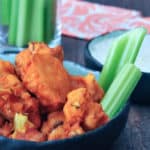 Buffalo cauliflower with celery sticks and bowl of Ranch dressing