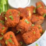Buffalo tofu nuggets in a bowl with celery sticks and Ranch dressing