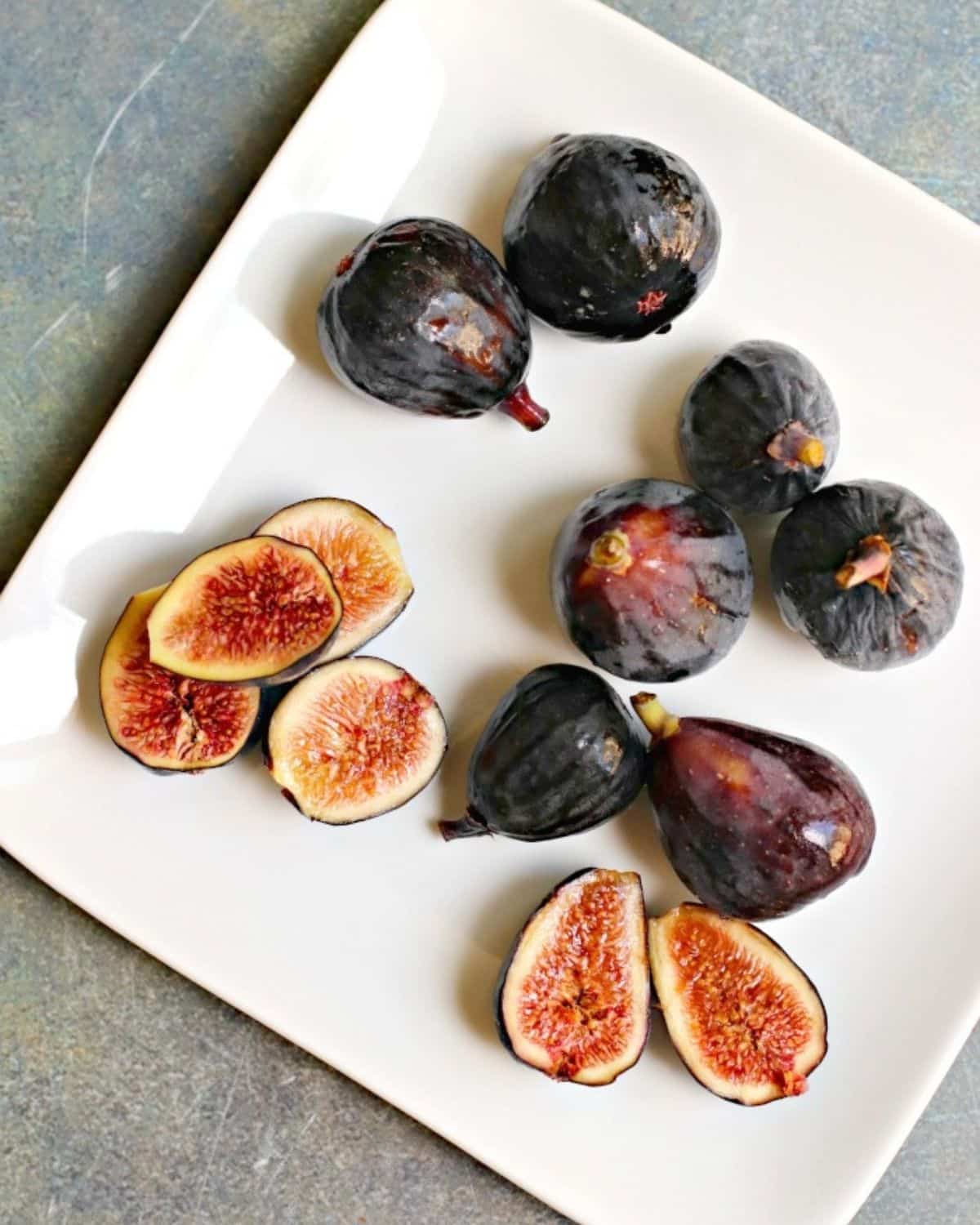 Plate of fresh figs with some of them sliced open