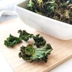 Seasoned air fried kale chips in a bowl.