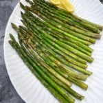 Platter of asparagus with lemon wedge