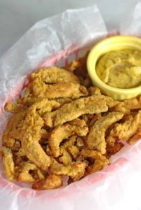 Basket of breaded soy curls with dipping sauce
