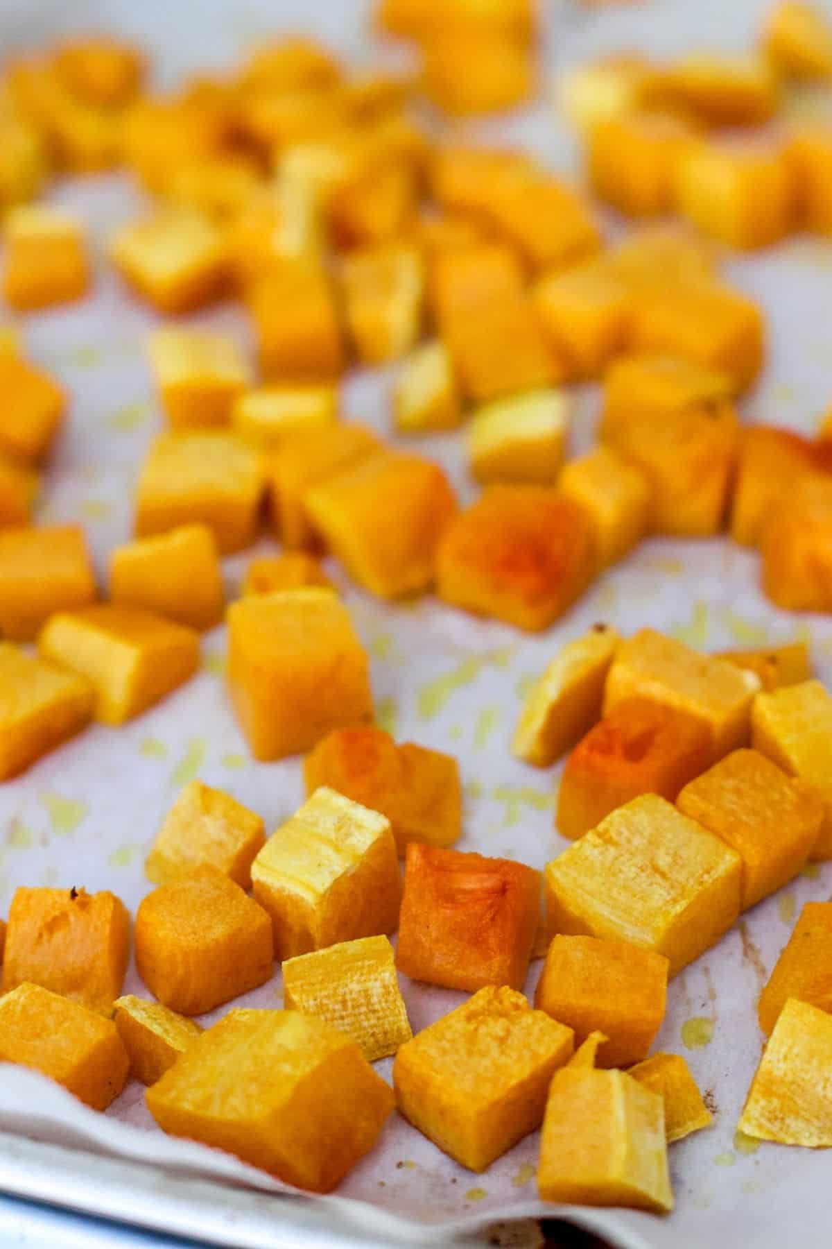 Baking sheet with roasted butternut squash.