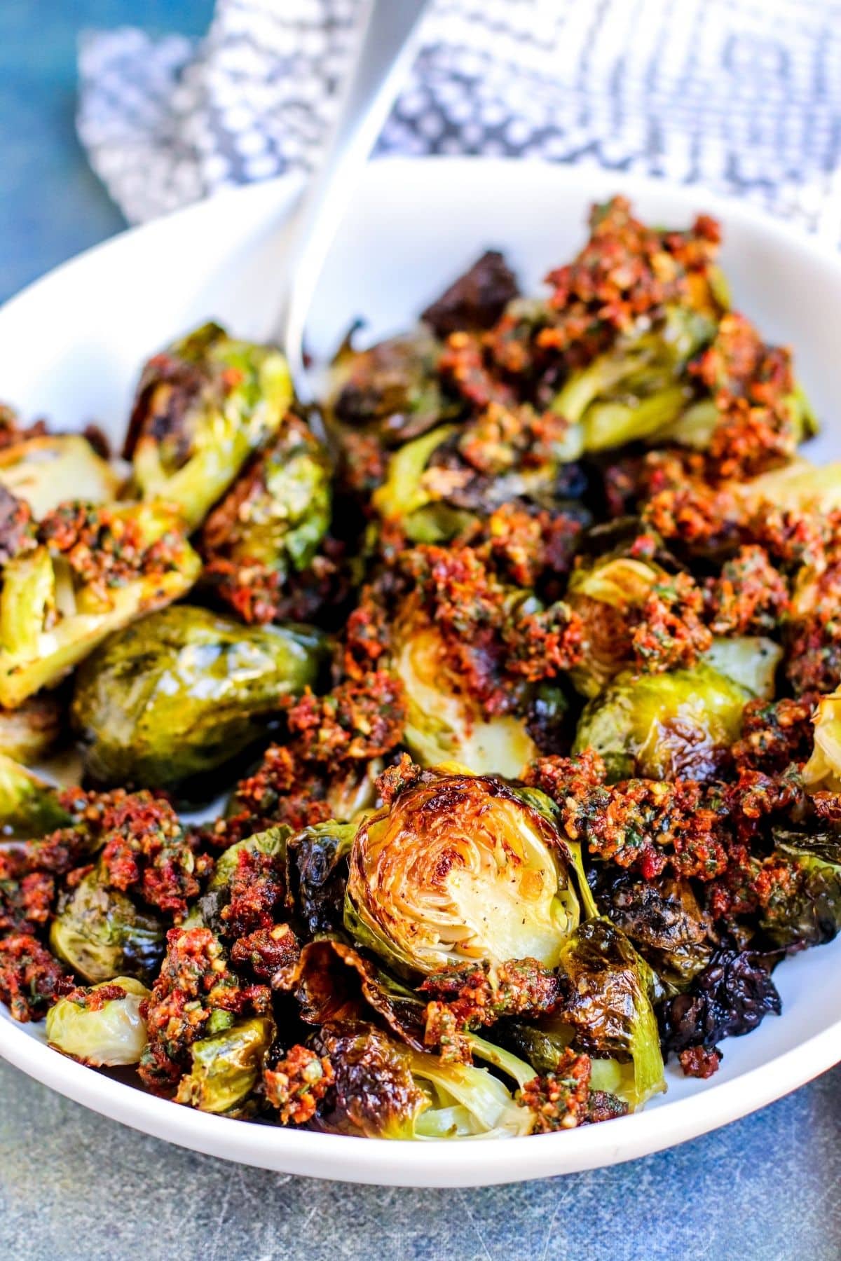 Close up of Brussels sprouts tossed with sun-dried tomato pesto.