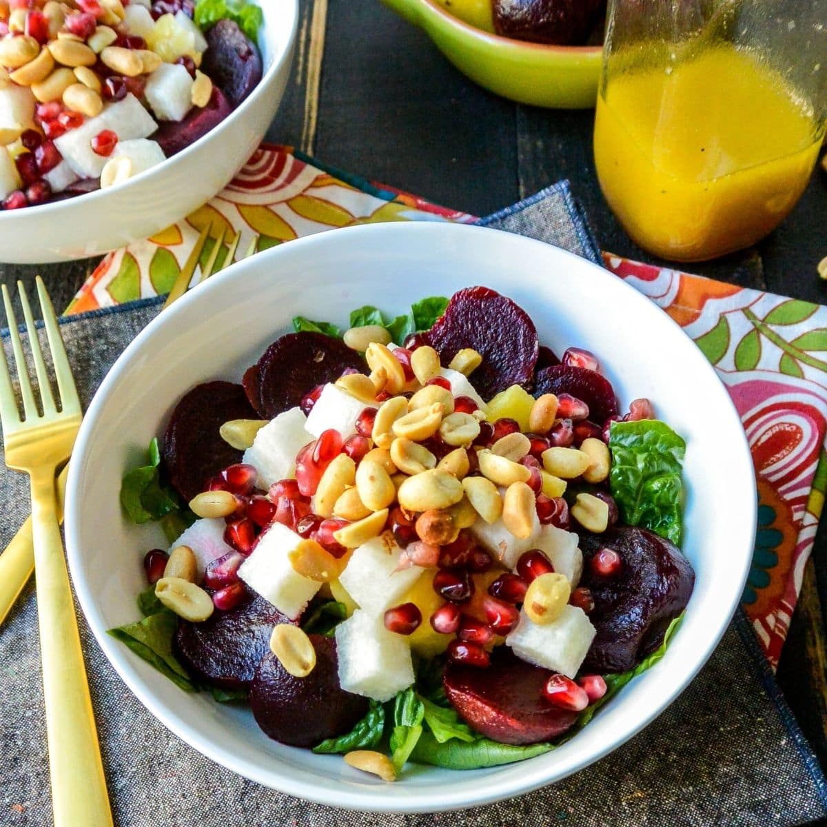 Bowls of salad with gold forks.