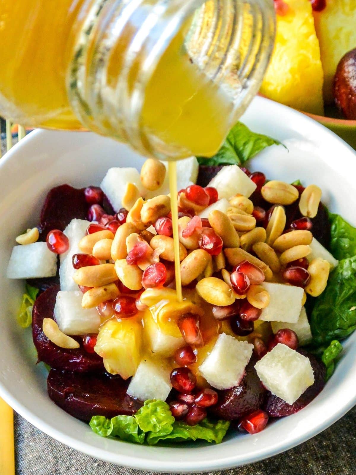 Pouring dressing over a salad.