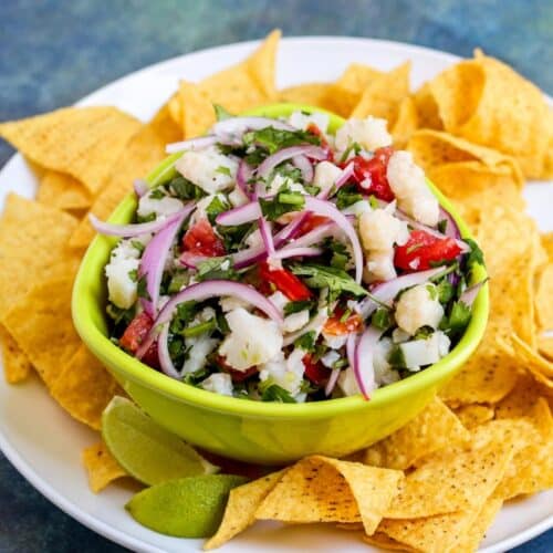 Bowl of cauliflower ceviche surrounded by tortilla chips.