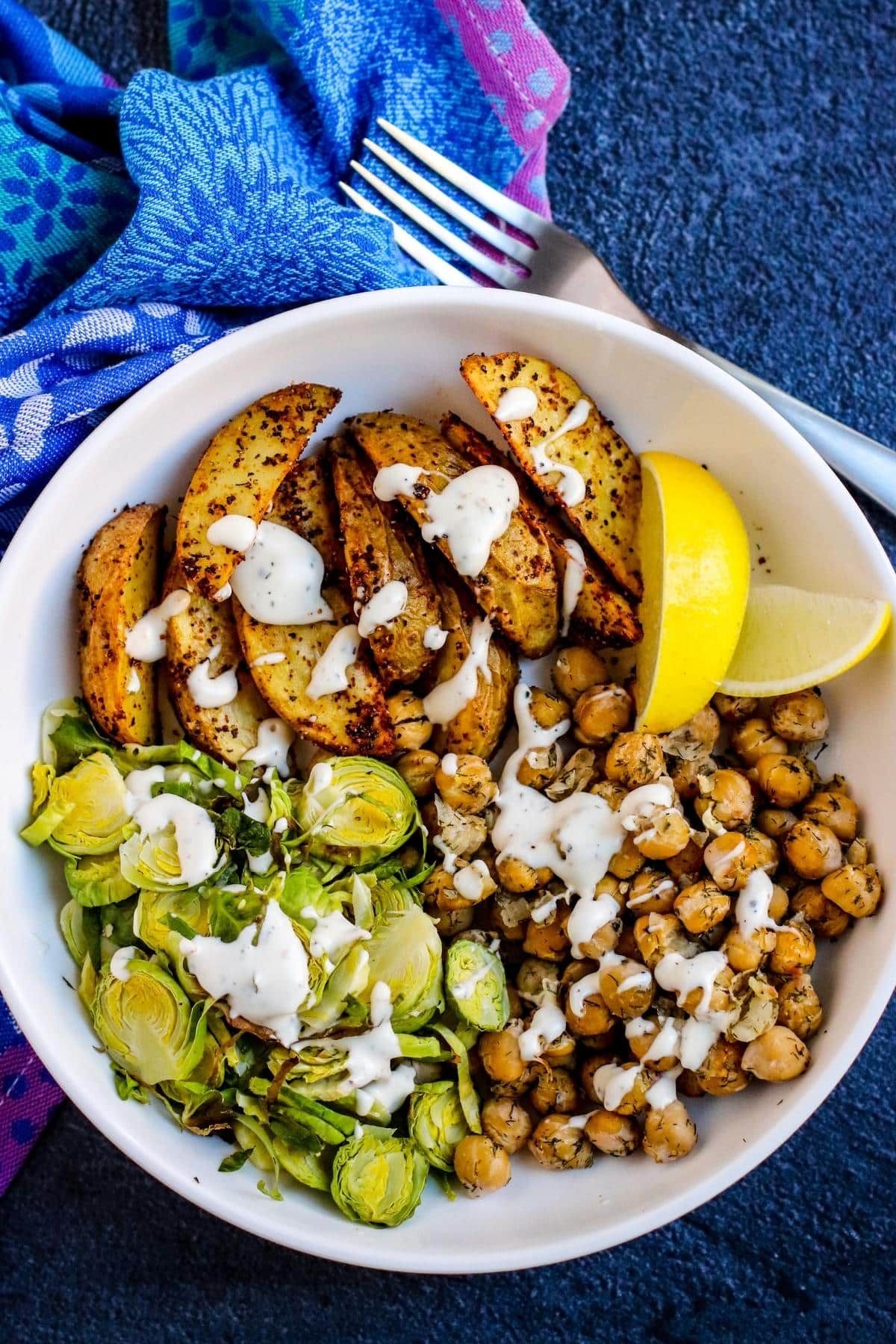 Chickpea bowl drizzled with sunflower sour cream sauce.