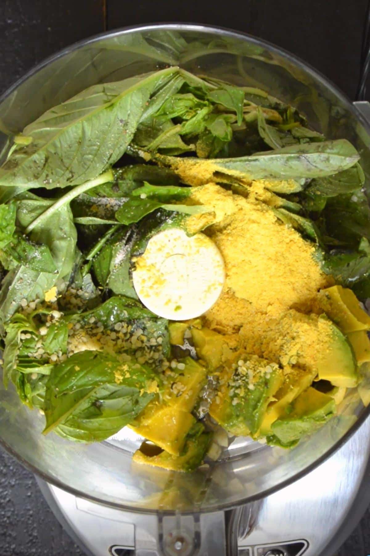 Pasta sauce ingredients in the bowl of a food processor.