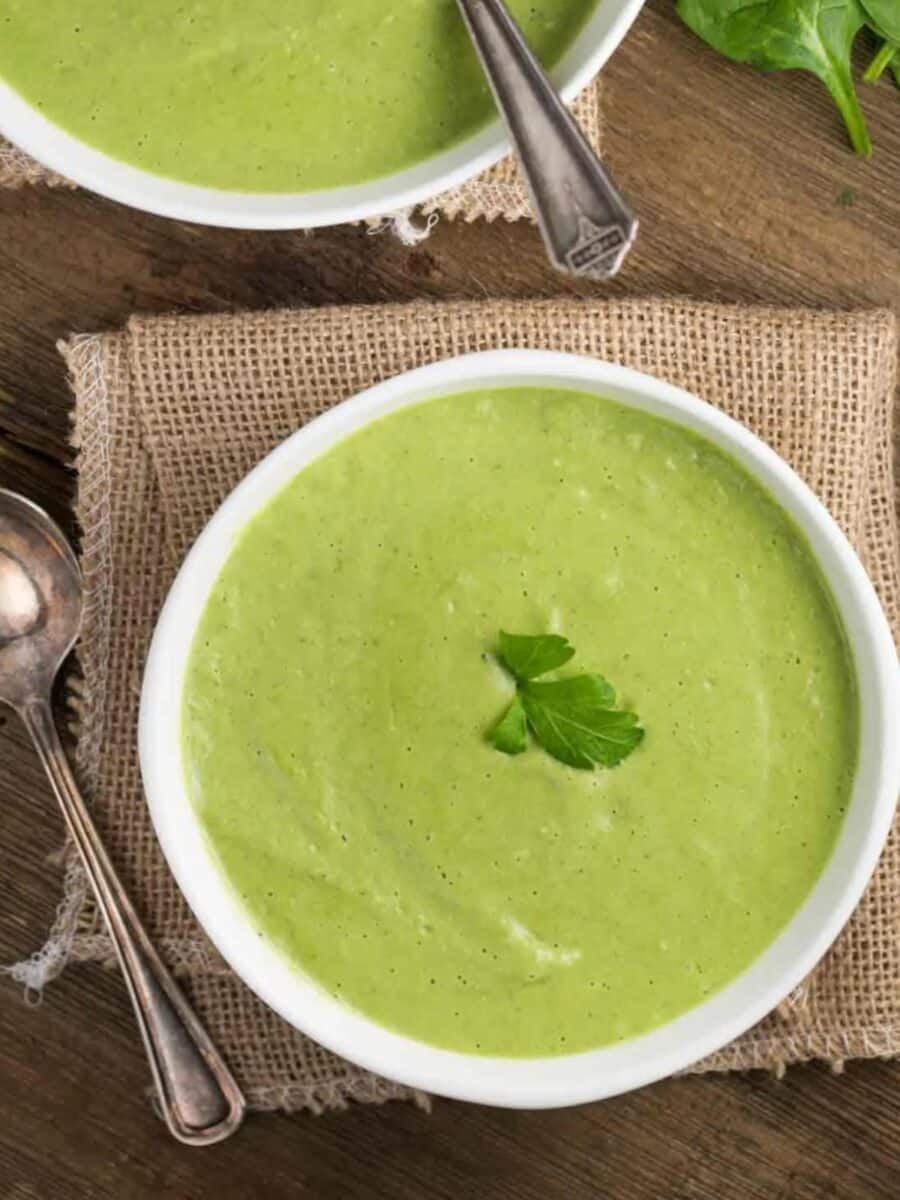 Bowls of Asparagus Spinach Soup with spoons.