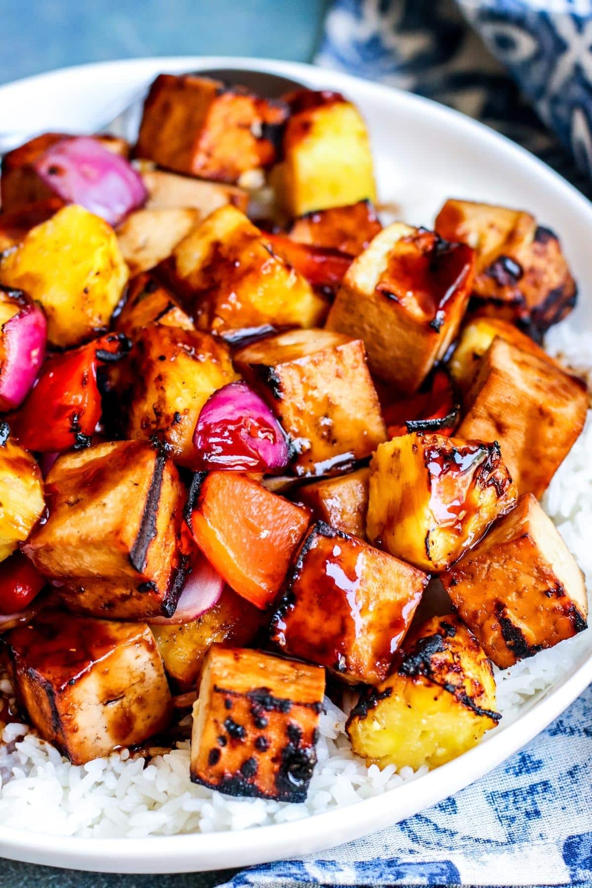 Close up of teriyaki tofu on a bed of rice.