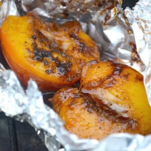 Grilled nectarines on foil.