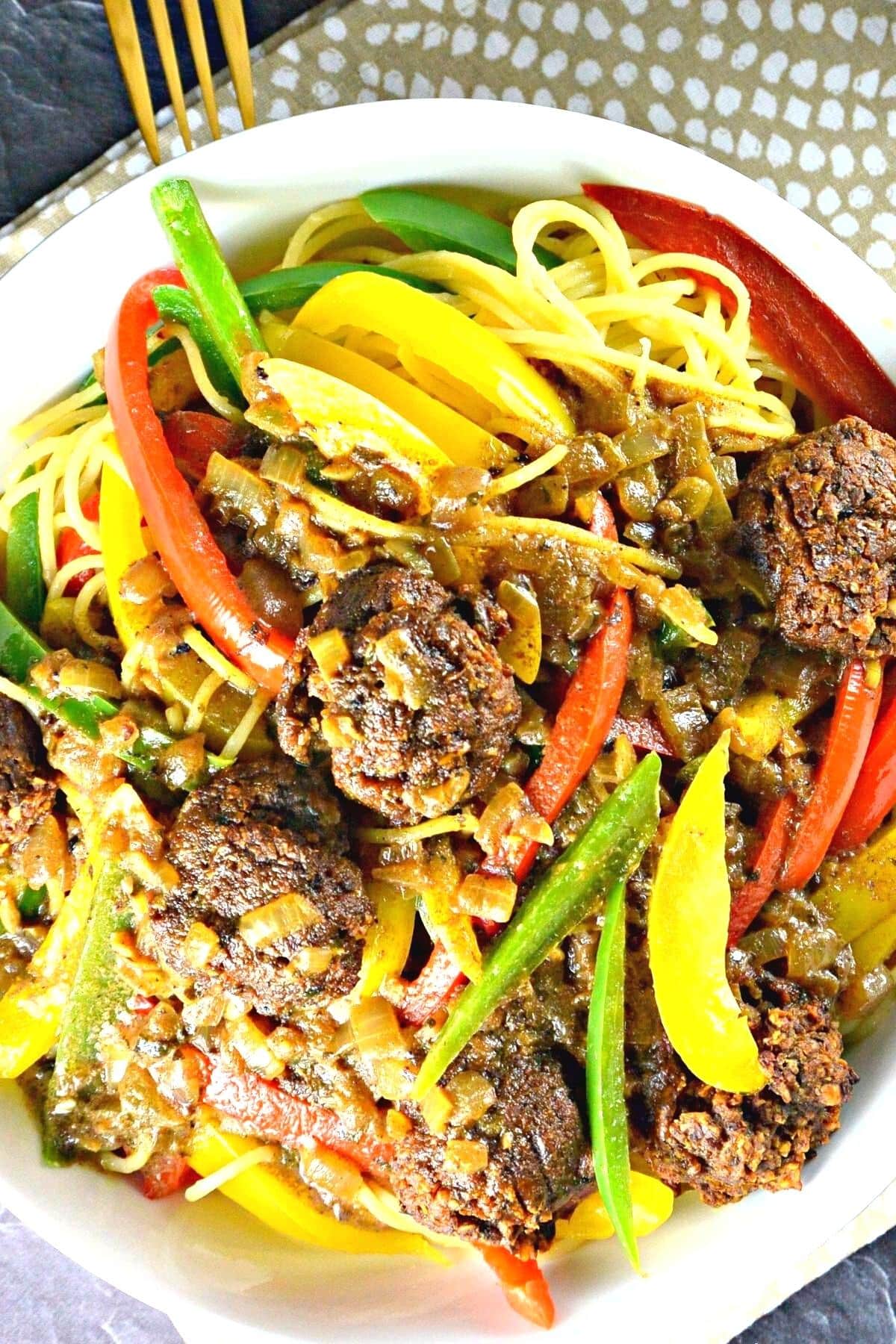 Overhead of bowl of vegan rasta pasta with walnut meatballs.