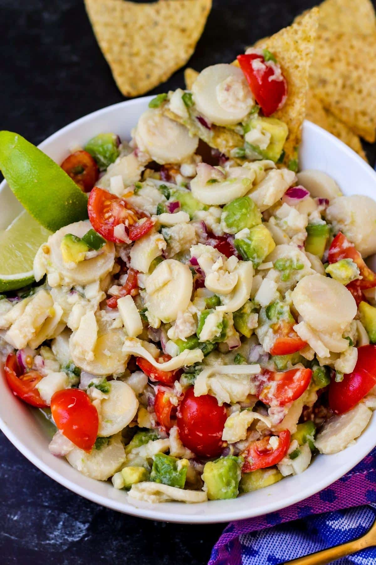 Close up of bowl of ceviche with tortilla chips.