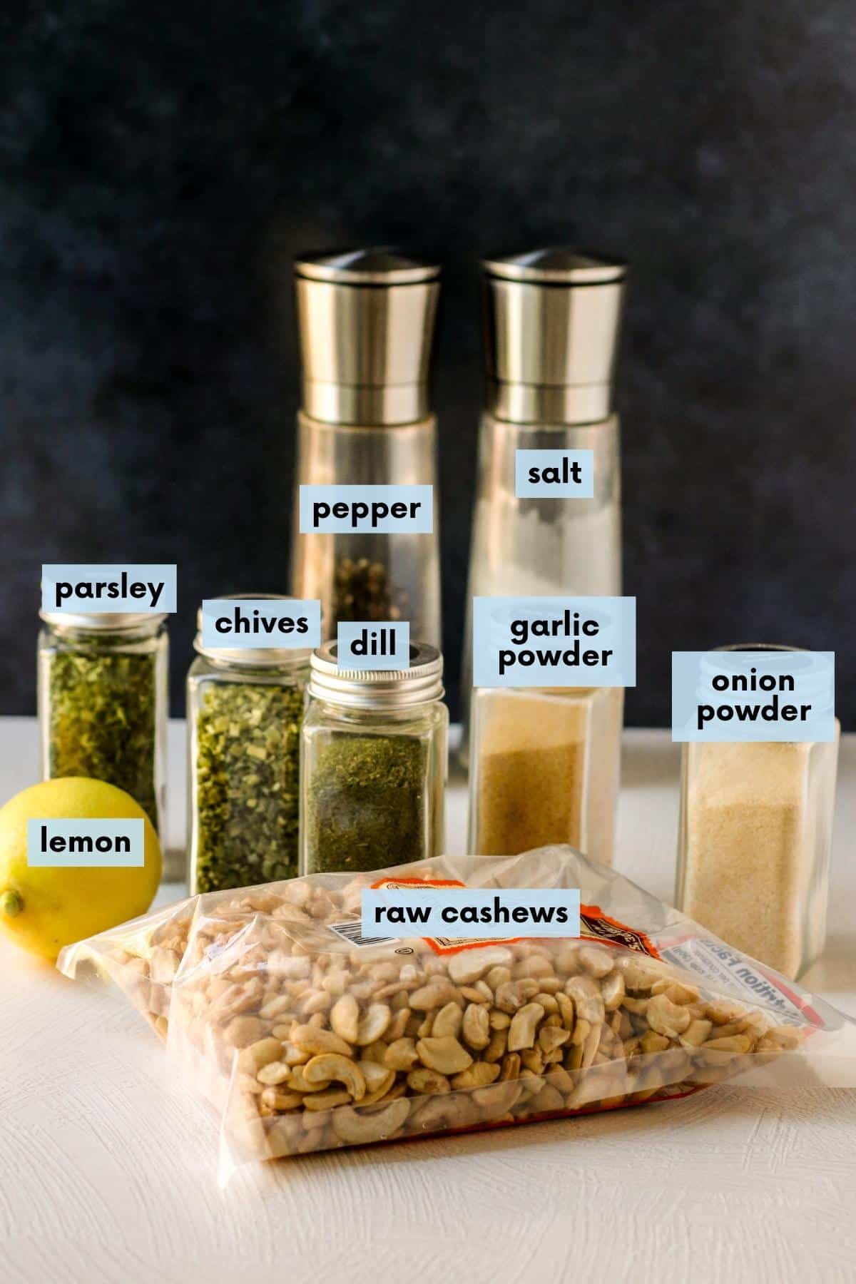 Labeled ingredients needed to make this recipe: Raw cashews, lemon, parsley, chives, dill, garlic powder, onion powder, pepper and salt.