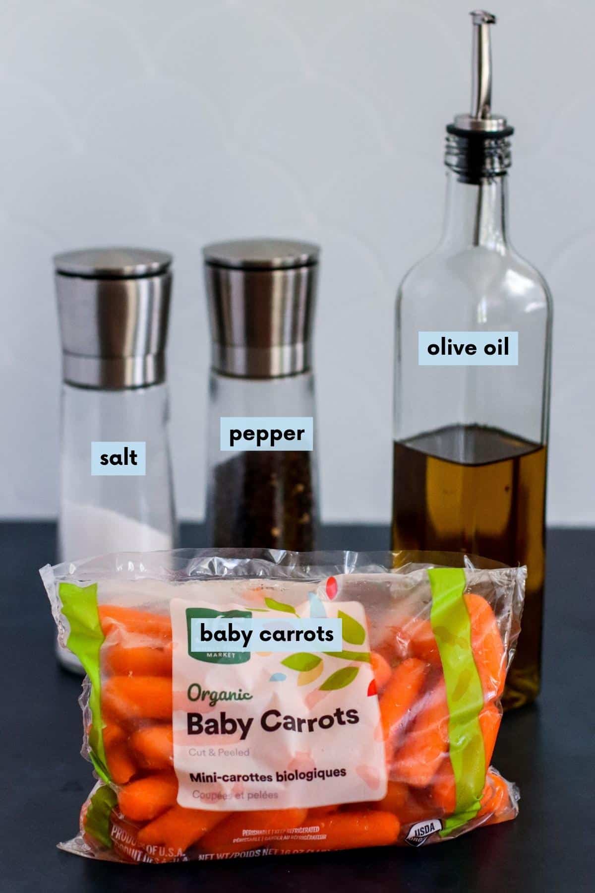 Bag of baby carrots, salt and pepper shakers, and a bottle of olive oil.