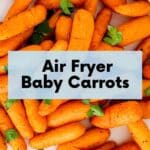 Plate of cooked carrots with text overlay Air Fryer Baby Carrots.