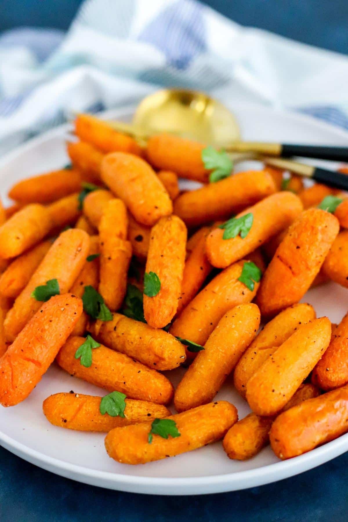 Close up of cooked carrots on a platter.