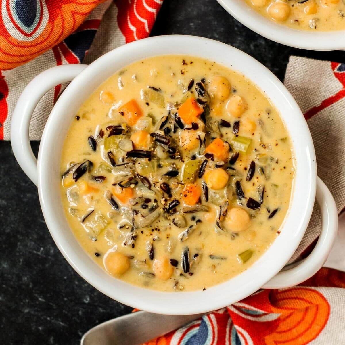 Vegan chickpea wild rice soup in a white bowl.