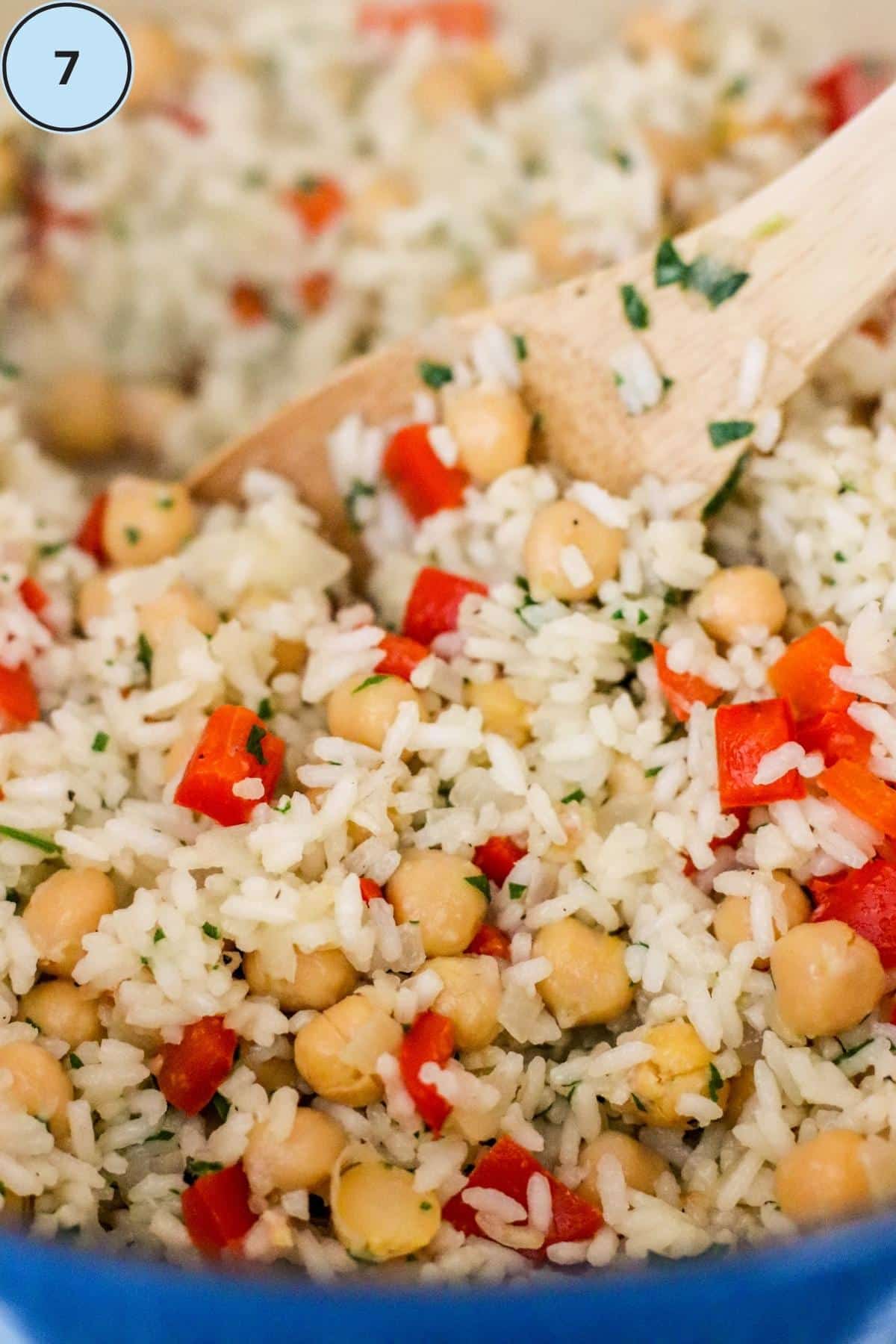 Step 7, folding the chickpeas and parsley into the finished rice dish.
