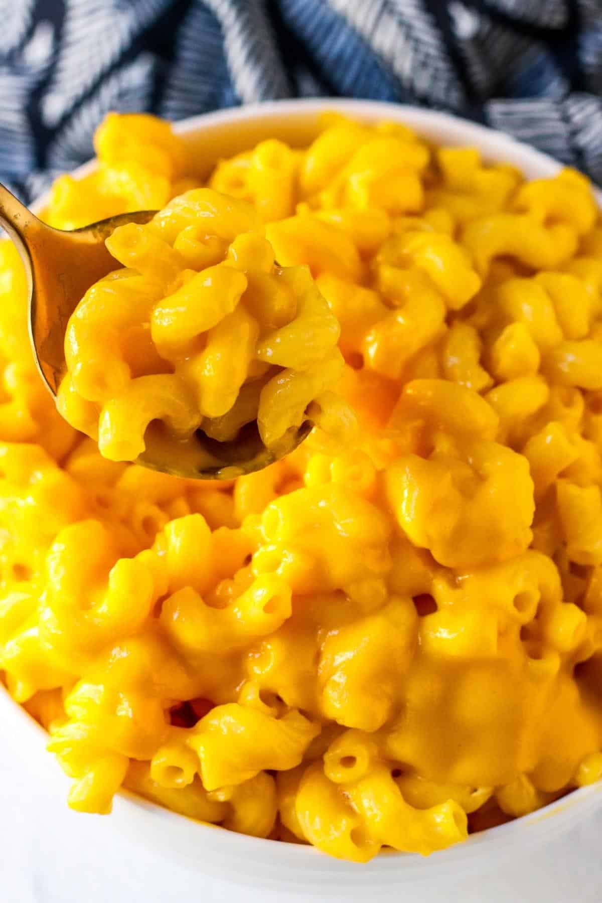 Serving spoon in a bowl of mac and cheese.