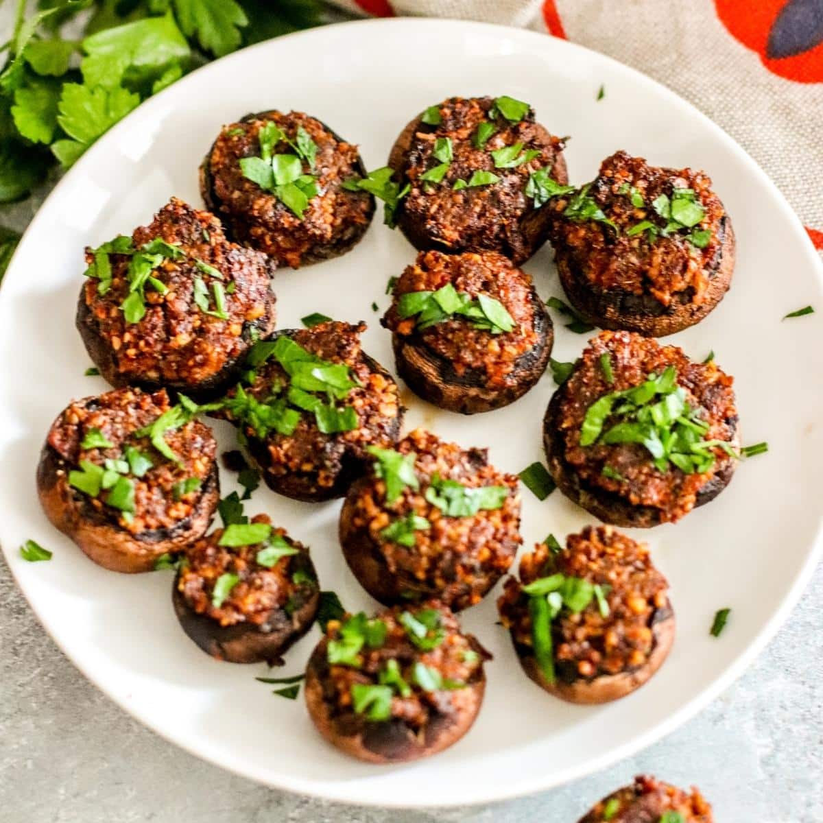 Platter of stuffed mushrooms garnished with fresh parsley.