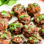 Stuffed mushrooms on a serving plate.