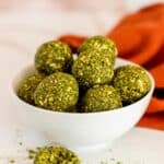 Bowl of Matcha Balls with one in front with a bite taken out of it.