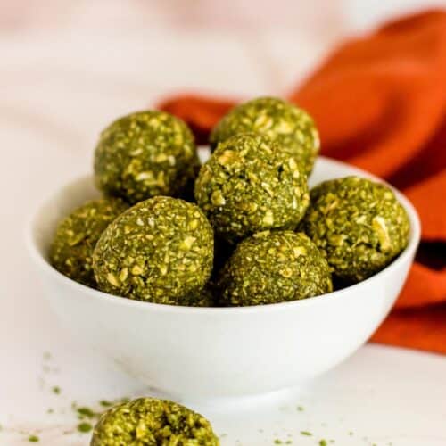 Bowl of Matcha Balls with one in front with a bite taken out of it.
